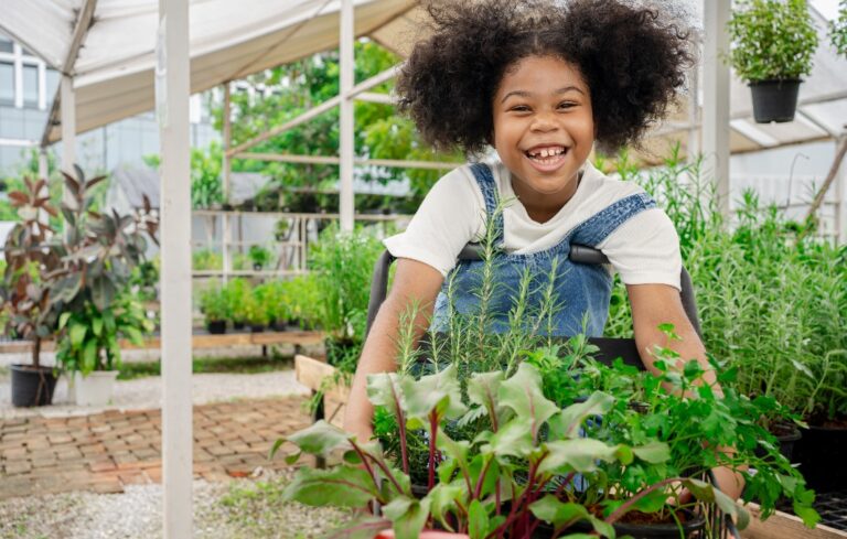 Girl working in backyard greenhouse