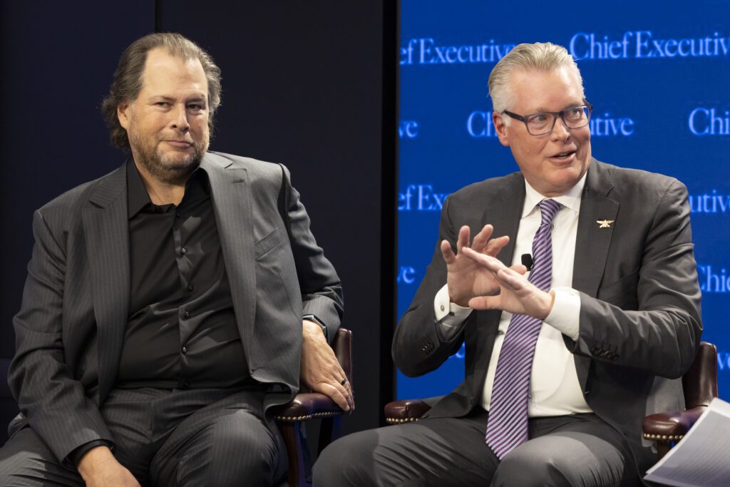 Marc Benioff and Ed Bastion seated on stage during a panel conversation