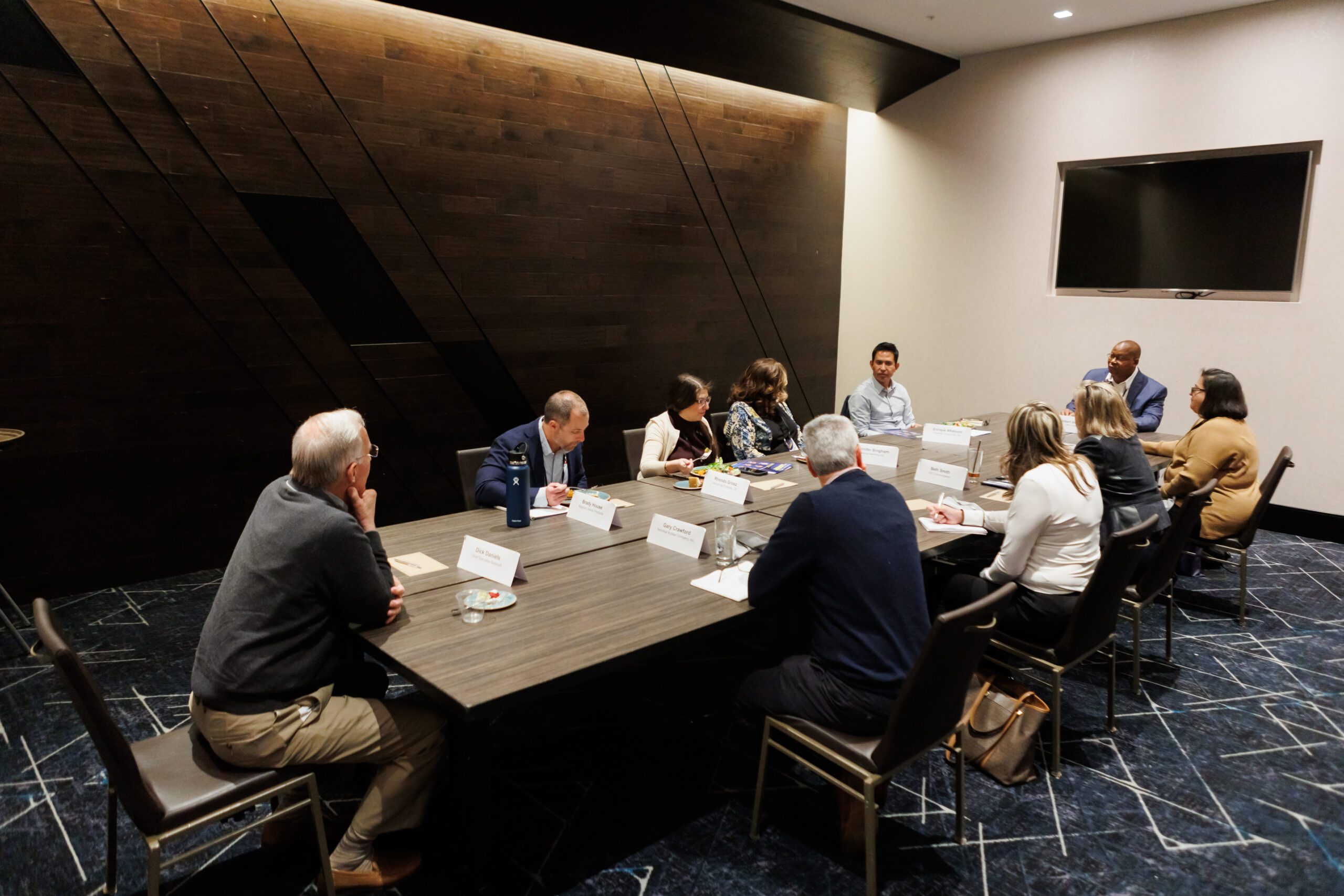 Event attendees seated around a boardroom table