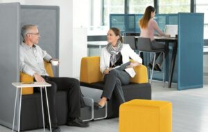 Two people talking in an office cubicle