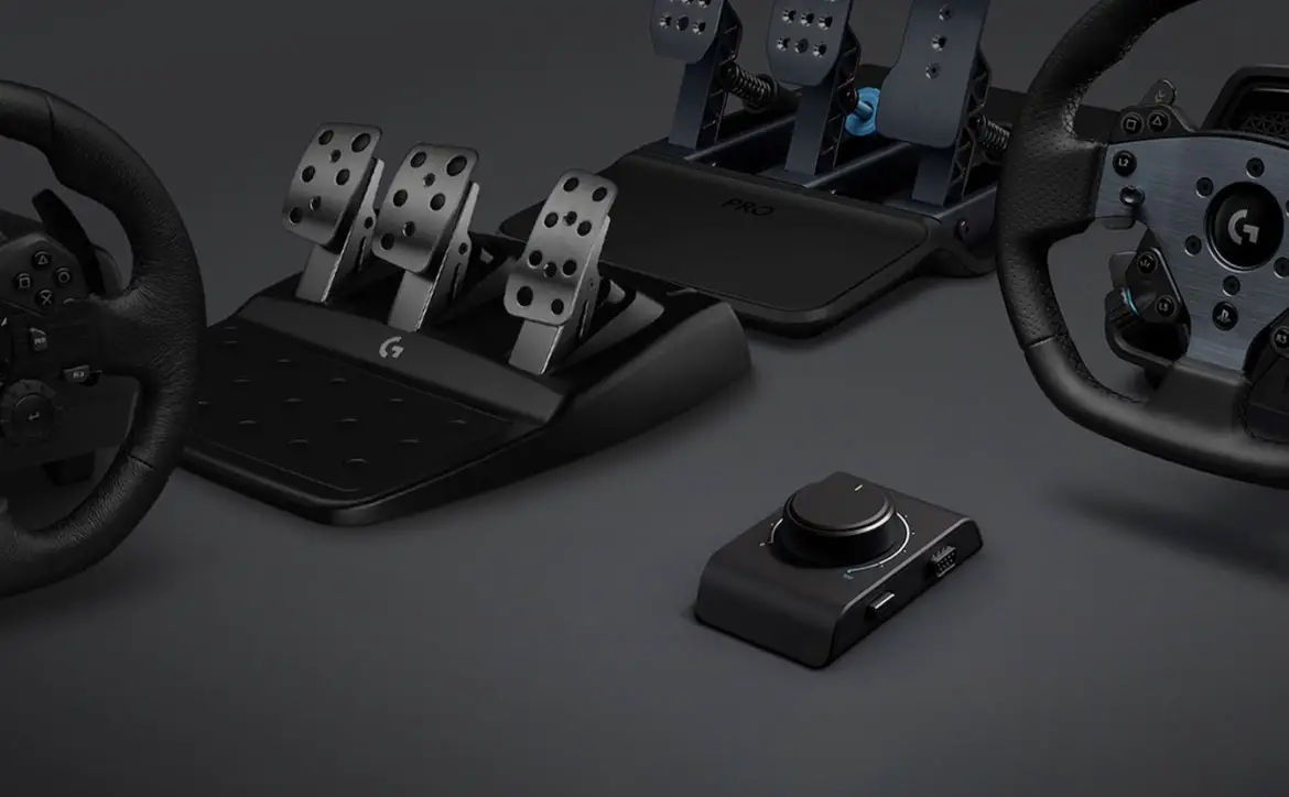 The Logitech G Racing Adapter shown with older and newer Logitech G racing wheel and racing pedals peripherals