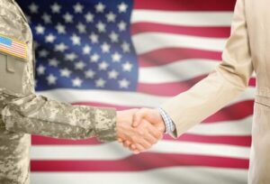 Soldier and businessman shaking hands